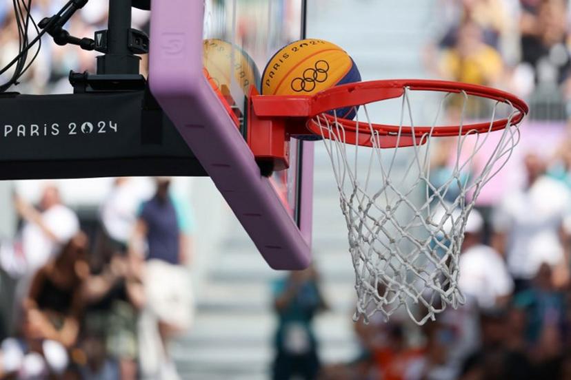 The basketball is seen on the hoop in the women's pool round 3x3 basketball game between Azerbaijan and France during the Paris 2024 Olympic Games at La Concorde in Paris on August 1, 2024. David GRAY / AFP