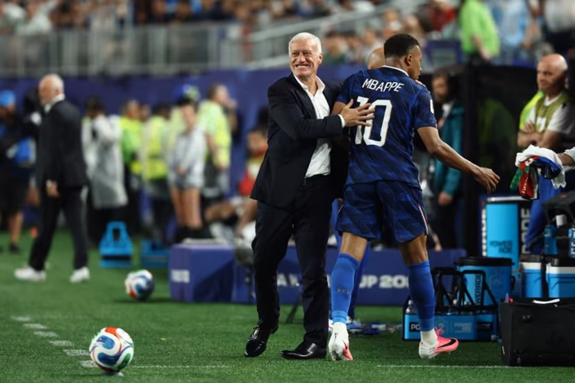 France's forward #10 Kylian Mbappe hugs head coach Didier Deschamps after being substituted during the 2026 World Cup Group I football match between France and Iraq at the Philadelphia Stadium in Philadelphia on June 22, 2026. FRANCK FIFE / AFP