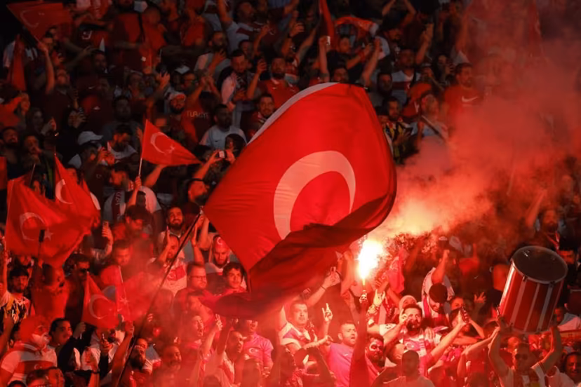 Turkey fans light flares and some make the controversial hand gesture associated with Turkish right-wing extremist group Grey Wolves during the UEFA Euro 2024 quarter-final football match between the Netherlands and Turkey at the Olympiastadion in Berlin on July 6, 2024. Odd ANDERSEN / AFP