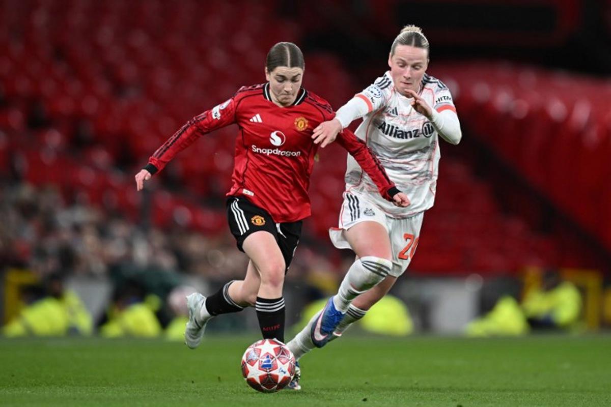 Manchester United's English forward #08 Jessica Park (L) and Bayern Munich's German forward #20 Franziska Kett (R) fight for the ball during the UEFA Women's Champions League, Quarter Final first-leg football match between Manchester United and Bayern Munich at Old Trafford in Manchester, north west England, on March 25, 2025. Paul ELLIS / AFP