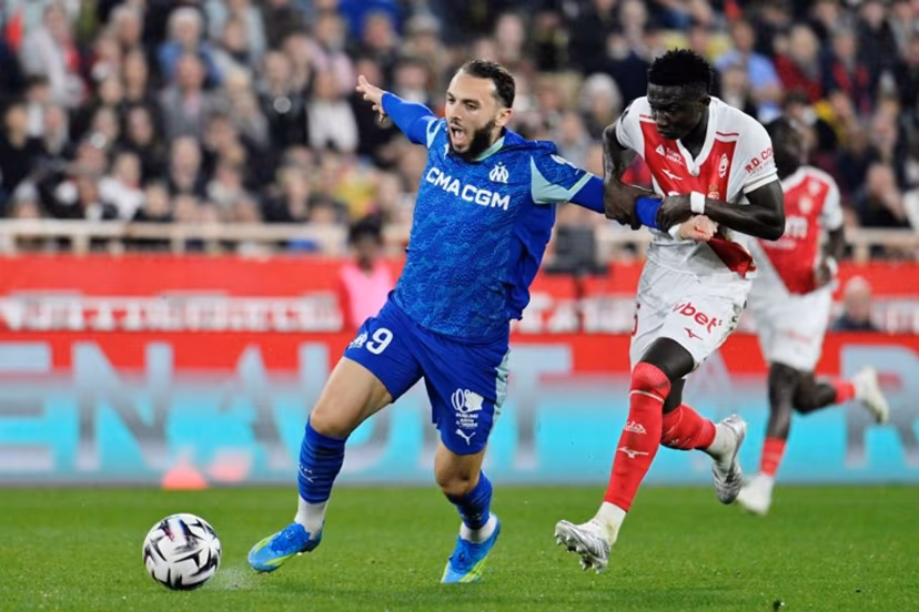 Marseille's Algerian forward #09 Amine Gouiri (L) vies with Monaco's Senegalese midfielder #15 Lamine Camara (R) during the French L1 football match between Monaco (ASM) and Olympique de Marseille (OM) at the Louis II Stadium in Monaco on April 5, 2026. Frederic DIDES / AFP