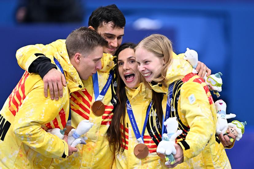 Belgian shorttrack skater Ward Petre, Belgian shorttrack skater Stijn Desmet, Belgian shorttrack skater Hanne Desmet and Belgian shorttrack skater Tineke den Dulk celebrate their bronze medal on the podium of the Mixed Team Relay of the Short Track Speed Skating competition at the Milano Cortina 2026 Olympic Winter Games, on Tuesday 10 February 2026 in Milan, Italy. The XXV Winter Olympics take place from 6 to 22 February 2026 in Italy. BELGA PHOTO JASPER JACOBS