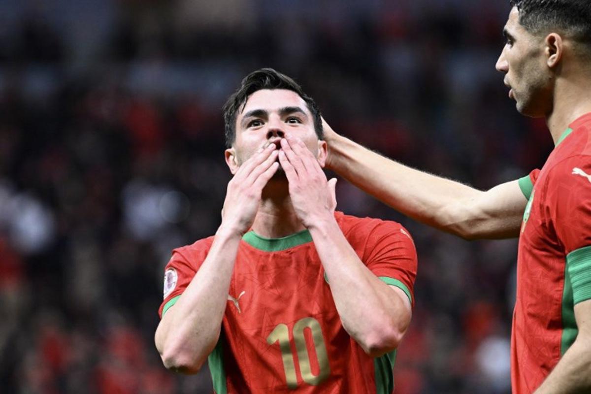 Morocco's forward #10 Brahim Diaz celebrates scoring his team's first goal next to Morocco's defender #02 Achraf Hakimi during the Africa Cup of Nations (CAN) round of 16 football match between Morocco and Tanzania at Prince Moulay Abdallah Stadium in Rabat on January 4, 2026. SEBASTIEN BOZON / AFP