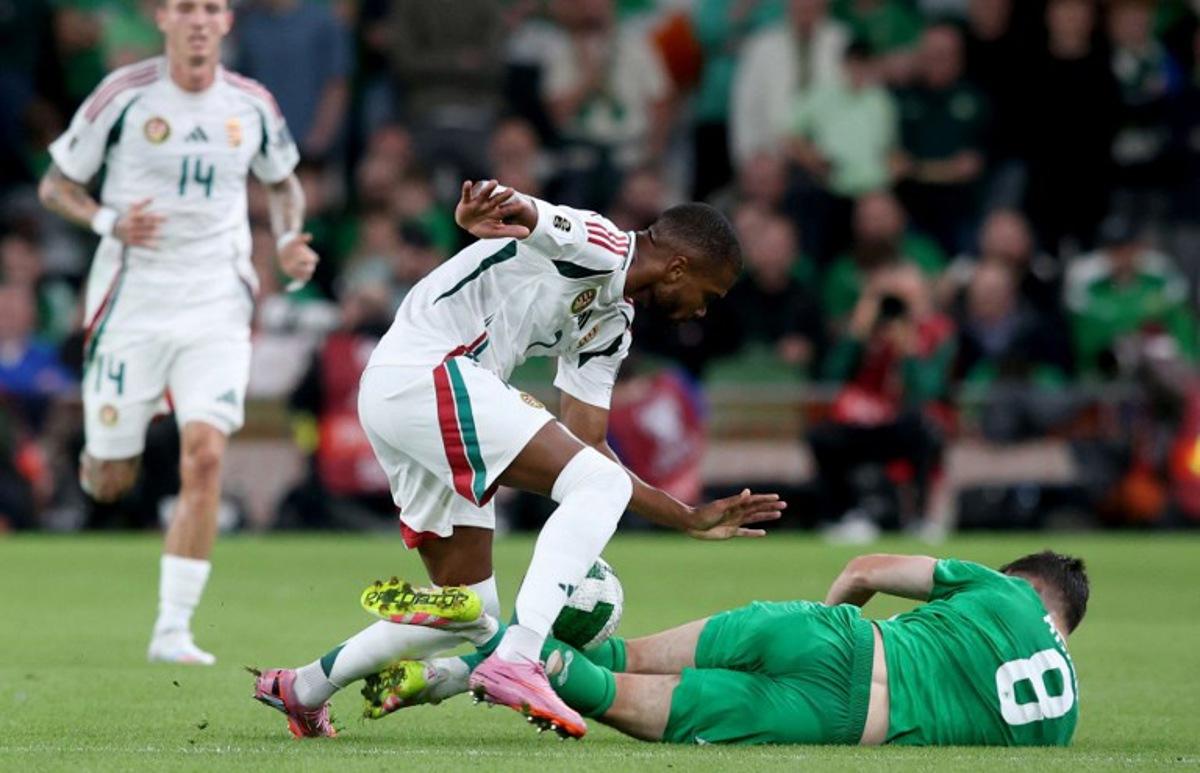 Hungary's goalkeeper #12 Balazs Toth battles for the ball with Republic of Ireland's midfielder #08 Jason Knight during the 2026 World Cup Group F qualifier football match between Republic of Ireland and Hungary, at Aviva Stadium, in Dublin, on September 6, 2025. Paul Faith / AFP