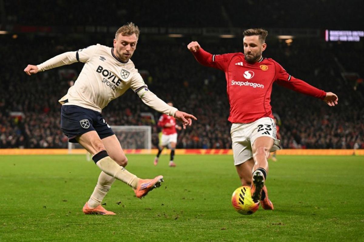 Manchester United's English defender #23 Luke Shaw blocks a cross from West Ham United's English striker #20 Jarrod Bowen during the English Premier League football match between Manchester United and West Ham United at Old Trafford in Manchester, north west England, on December 4, 2025. Oli SCARFF / AFP