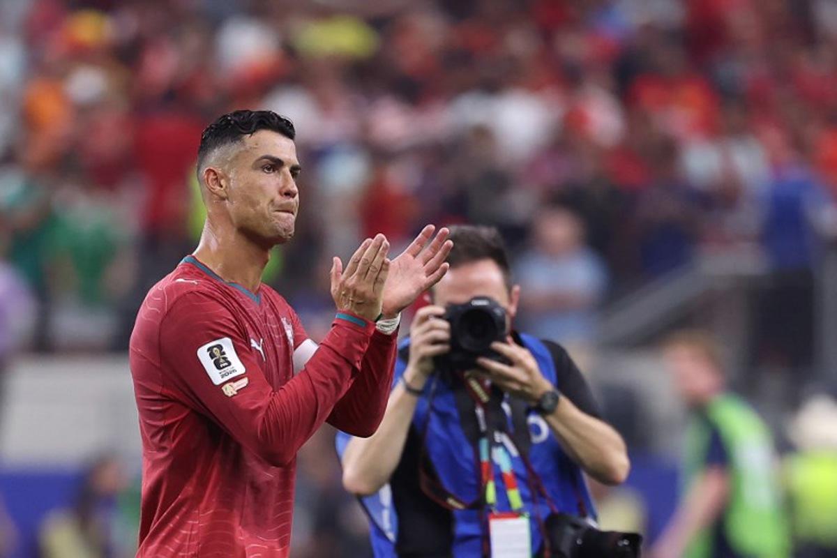 Portugal's forward #07 Cristiano Ronaldo greets fans after losing the 2026 World Cup round of 16 football match between Portugal and Spain at the Dallas Stadium in Arlington on July 6, 2026. Thomas COEX / AFP