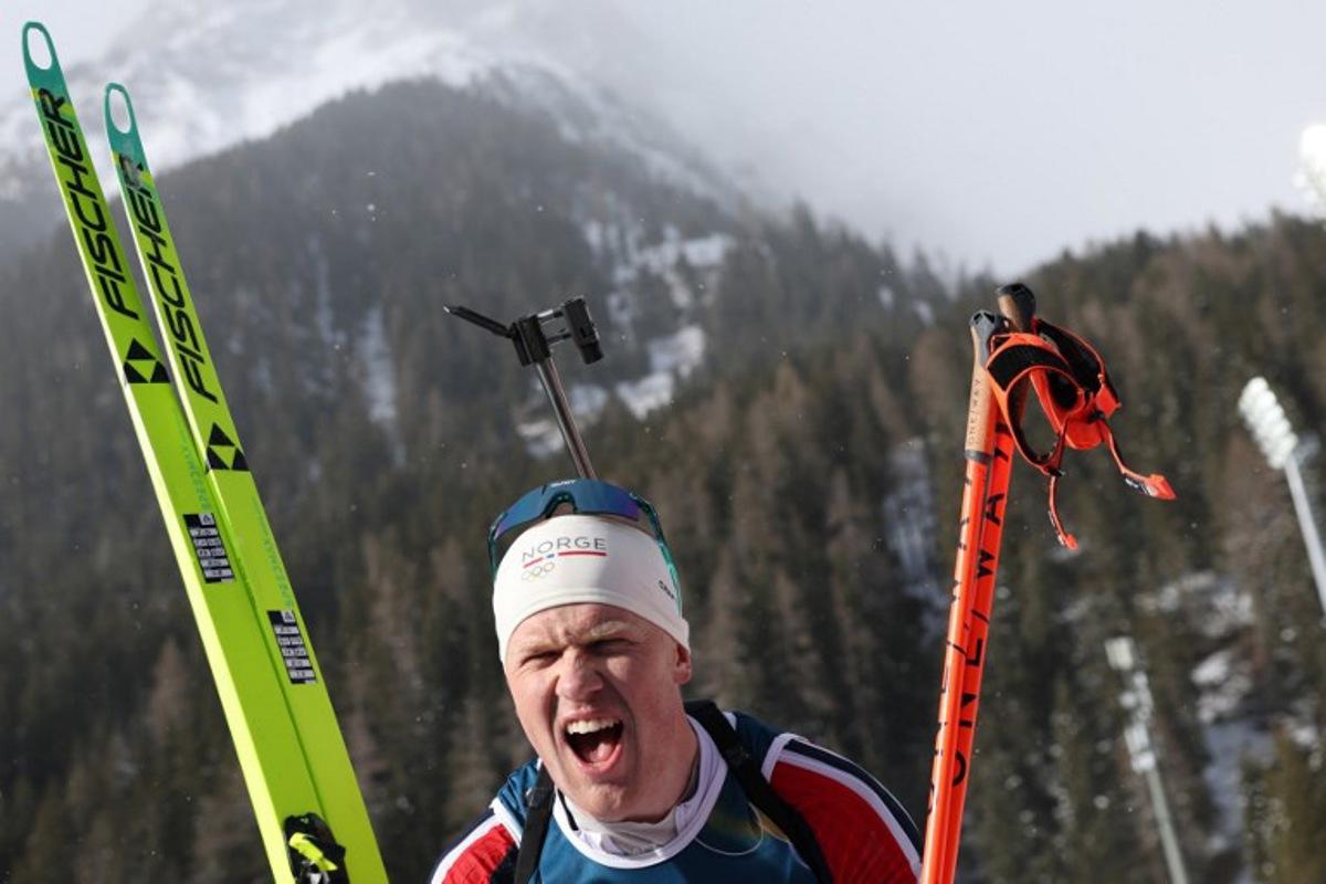 Norway's Johannes Dale-Skjevdal celebrates after he crossed the finish line to win gold during the men's biathlon 15km mass start event during the Milano Cortina 2026 Winter Olympic Games at the Anterselva Biathlon Arena (Sudtirol Arena) in Anterselva (Val Pusteria) on February 20, 2026. Odd ANDERSEN / AFP