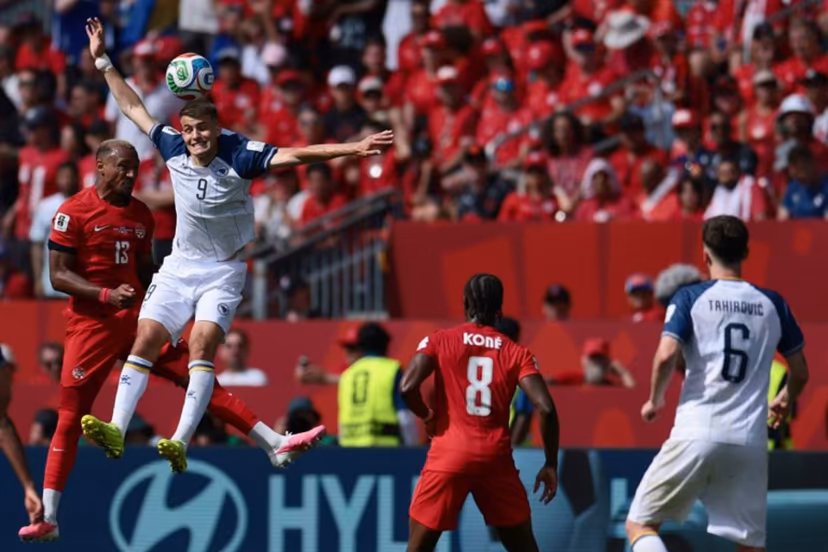 Canada's defender #13 Derek Cornelius (L) fights for the ball with Bosnia-Herzegovina's forward #09 Samed Bazdar (2ndL) during the 2026 World Cup Group B football match between Canada and Bosnia and Herzegovina at the Toronto Stadium in Toronto on June 12, 2026. Cole Burston / AFP