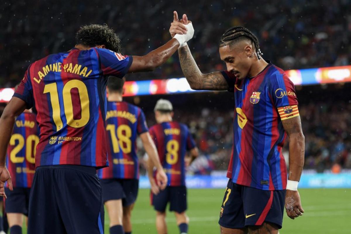 Barcelona's Brazilian forward #11 Raphinha celebrates scoring his team's second goal from the penalty spot with Barcelona's Spanish forward #10 Lamine Yamal during the Spanish league football match between FC Barcelona and Racing Santander at the Camp Nou stadium in Barcelona on September 16, 2026. Lluis GENE / AFP