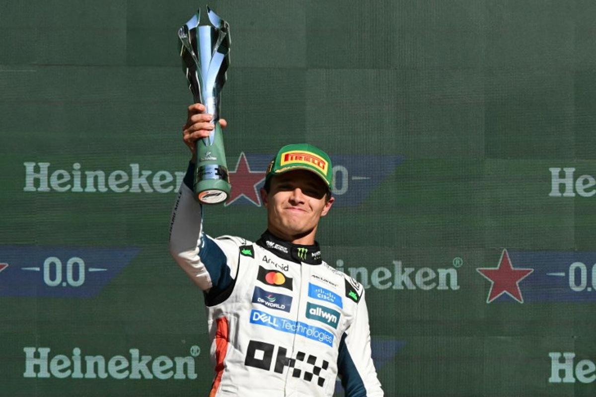McLaren's British driver Lando Norris lifts the trophy on the podium after winning the Mexico City Formula One Grand Prix at the Hermanos Rodriguez racetrack in Mexico City on October 26, 2025. Yuri CORTEZ / AFP