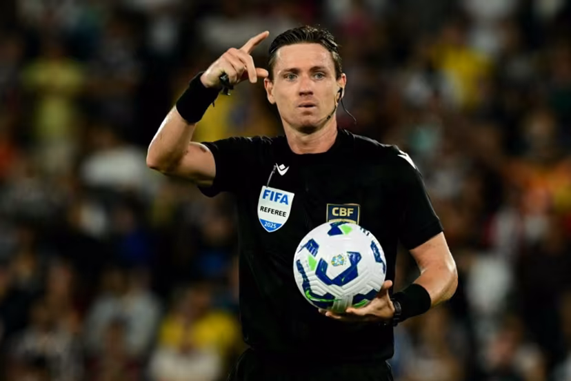 Brazilian referee Ramon Abatti gestures while holding the ball during the Brasileirao Seria A football match between Fluminense and Palmeiras at the Maracana Stadium in Rio de Janeiro, Brazil, on July 23, 2025. Pablo PORCIUNCULA / AFP