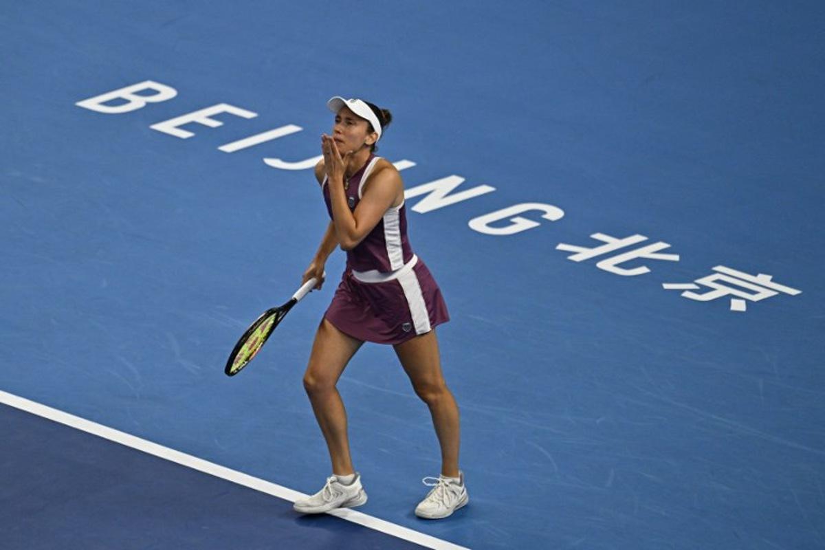 Belgium's Elise Mertens reacts after winning her women's singles quarter-final match against Poland's Iga Swiatek at the China Open tennis tournament in Beijing on October 9, 2026. Pedro Pardo / AFP