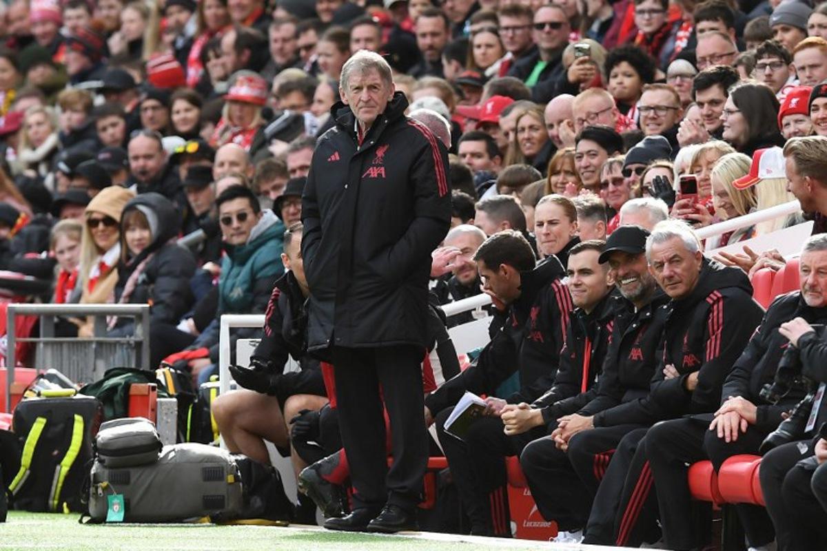 Liverpool Legends' manager Kenny Dalglish (C) looks on during the Legends football match between Liverpool Legends and Dortmund Legends at Anfield in Liverpool, north-west England on March 28, 2026. PETER POWELL / AFP