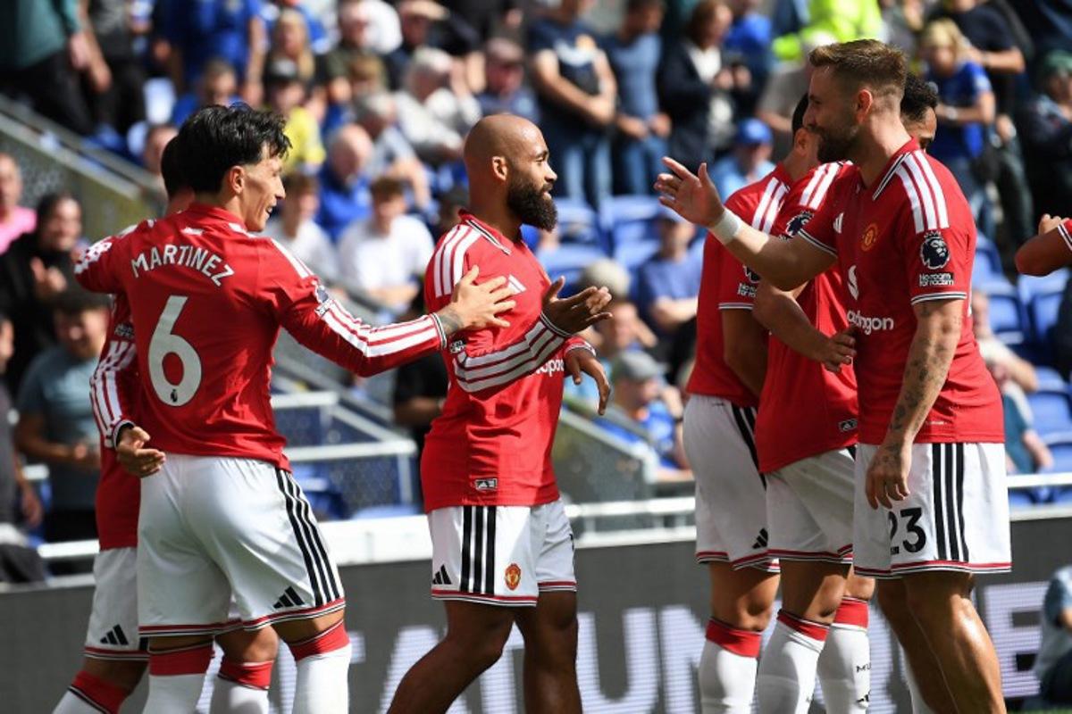 Manchester United's Cameroonian midfielder #19 Bryan Mbeumo (C) celebrates scoring the team's first goal during the English Premier League football match between Everton and Manchester United at Hill Dickinson Stadium in Liverpool, north-west England on September 6, 2026. PETER POWELL / AFP