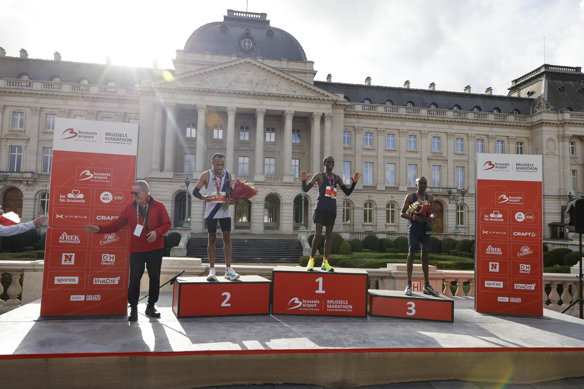 Ethiopian Solomon Belayneh, Kenyan Hillary Mutai and Kenyan Felix Mutai celebrate on the podium of the 2025 Brussels Marathon race on Sunday 02 November 2025 in Brussels. BELGA PHOTO NICOLAS MAETERLINCK