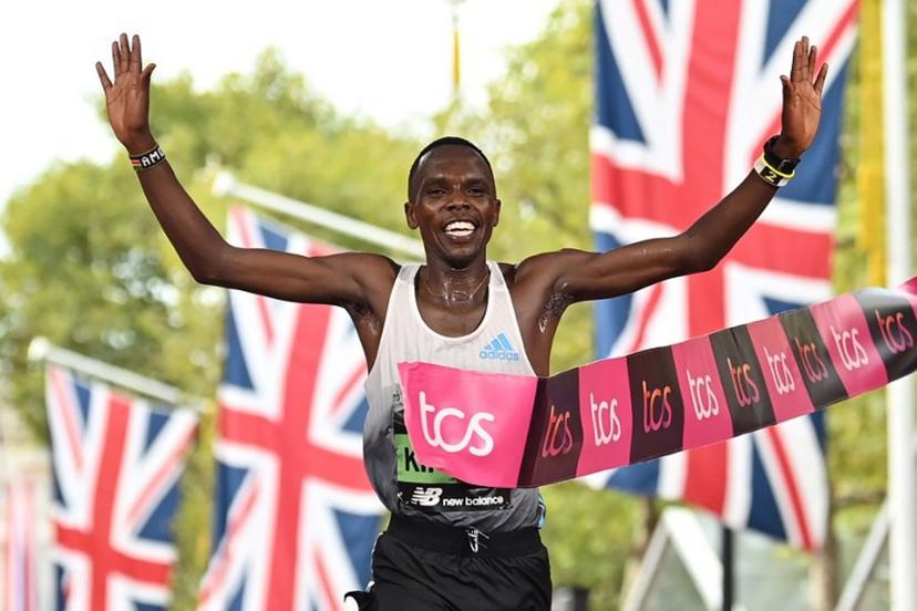 Kenya's Amos Kipruto breaks the tape to win the men's race at the finish of the 2022 London Marathon in central London on October 2, 2022. Glyn KIRK / AFP