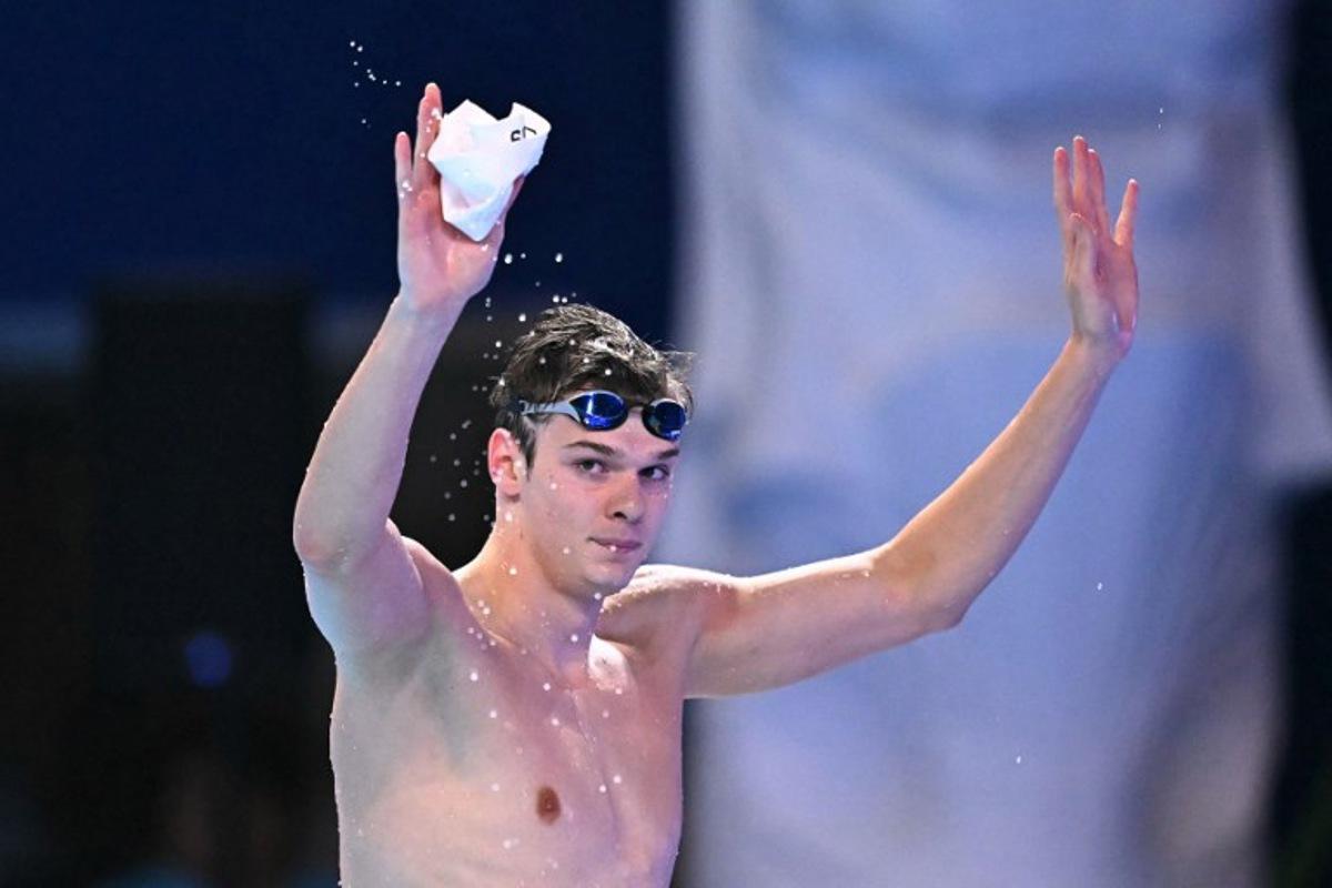 Hungary's swimmer Hubert Kos celebrates after the final of the men's 200m backstroke swimming event during the 2025 World Aquatics Championships in Singapore on August 1, 2025. MANAN VATSYAYANA / AFP