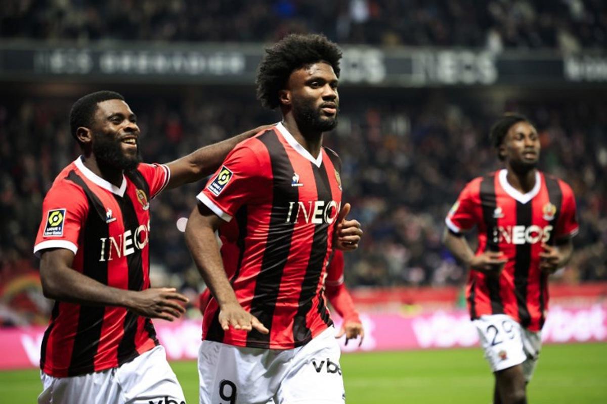 Nice's Nigerian forward #09 Terem Moffi (C) celebrates with Nice's Ivorian forward #07 Jeremie Boga (L) after scoring his side's second goal during the French L1 football match between OGC Nice and RC Lens at the Allianz Riviera Stadium in Nice, south-eastern France, on December 20, 2023. Valery HACHE / AFP