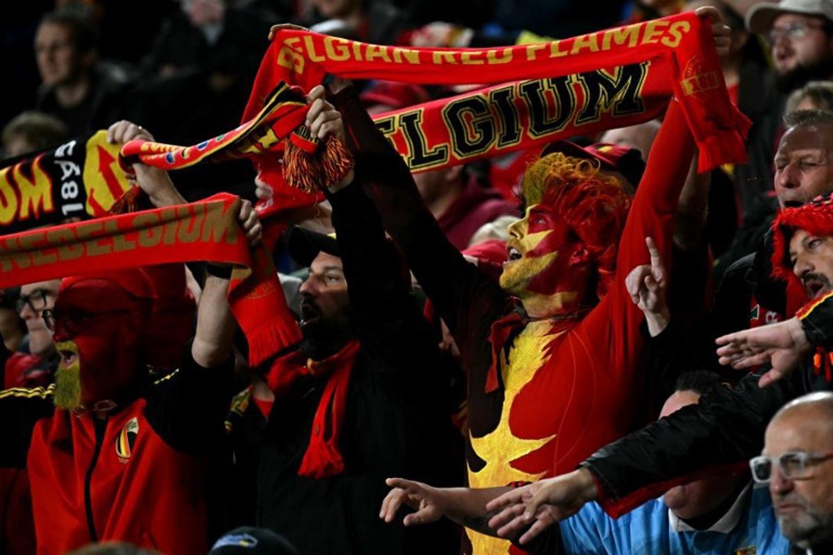 Fans holds aloft scarves during the 2026 World Cup Group J qualifier football match between Wales and Belgium, at Cardiff City Stadium, in Cardiff, on October 13, 2025. Paul ELLIS / AFP