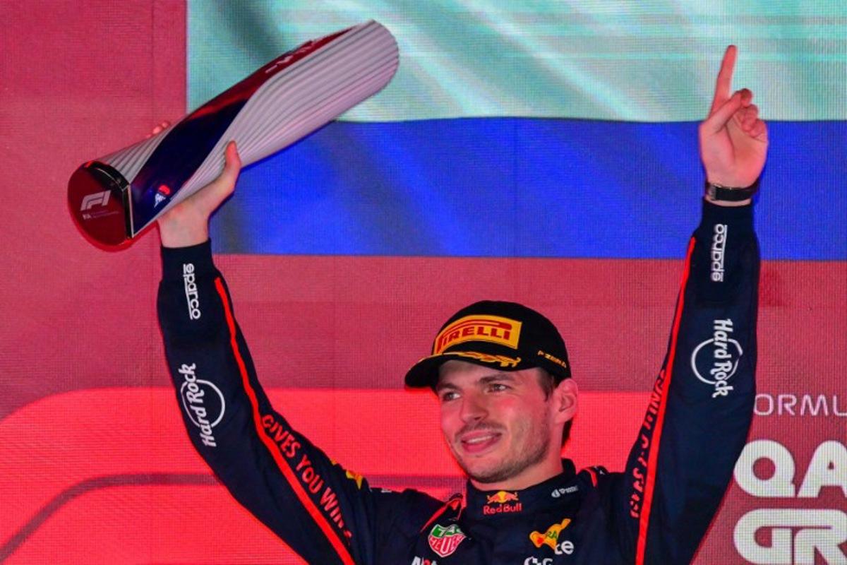 Red Bull Racing's Dutch driver Max Verstappen holds up the trophy on the podium after winning the Formula One Qatar Grand Prix at the Lusail International Circuit in Lusail on November 30, 2025. Andrej ISAKOVIC / AFP