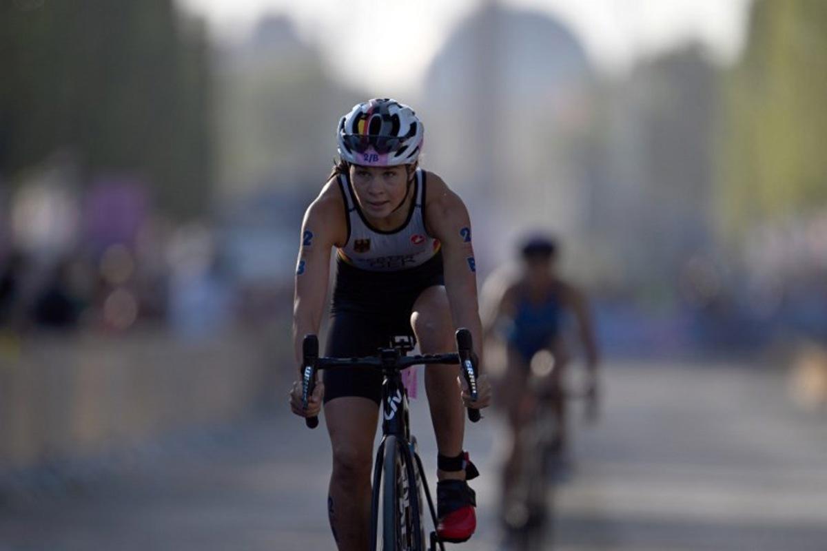 Germany's Lisa Tertsch competes in the cycling race, during the mixed's relay triathlon, at the Paris 2024 Olympic Games, in central Paris, on August 5, 2024. Mauro PIMENTEL / AFP
