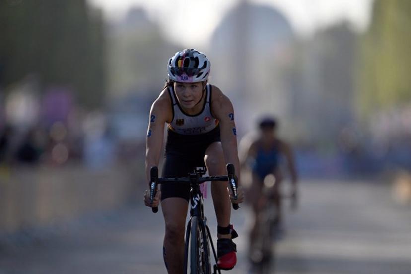 Germany's Lisa Tertsch competes in the cycling race, during the mixed's relay triathlon, at the Paris 2024 Olympic Games, in central Paris, on August 5, 2024. Mauro PIMENTEL / AFP