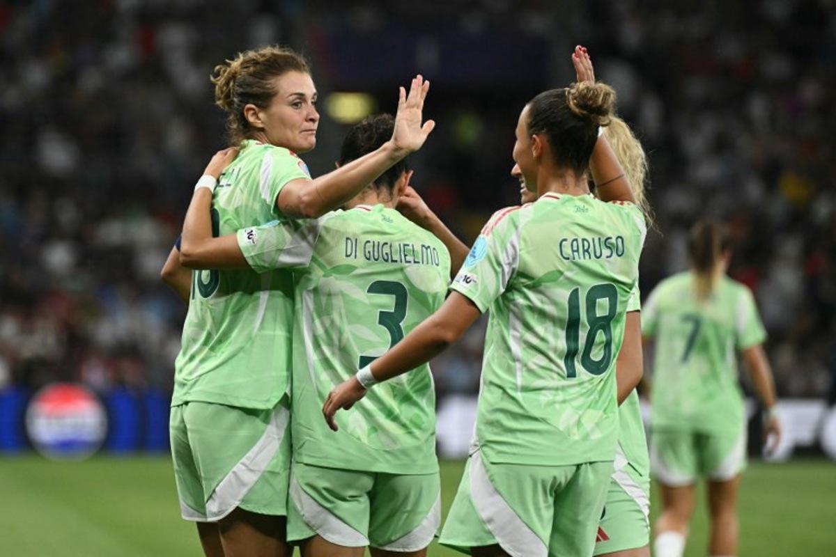 Italy's forward #10 Cristiana Girelli celebrates with teammates Italy's defender #03 Lucia Di Guglielmo, Italy's midfielder #08 Emma Severini and Norway's midfielder #18 Frida Maanum after scoring his team's first goal during the UEFA Women's Euro 2025 quarter-final football match between Norway and Italy at the Stade de Geneve in Geneva, on July 16, 2025. SEBASTIEN BOZON / AFP
