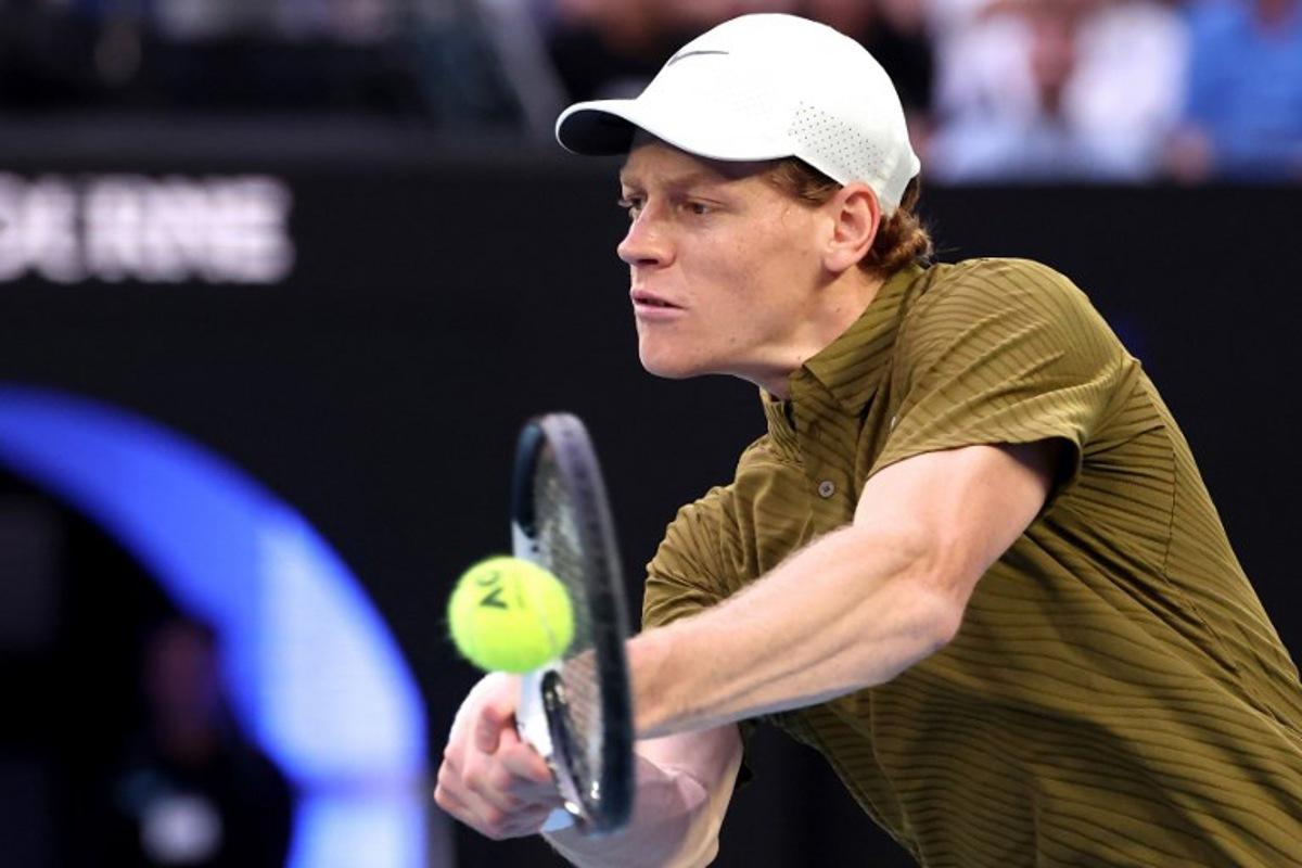 Italy's Jannik Sinner hits a return to USA's Ben Shelton during their men's singles quarter-final match on day eleven of the Australian Open tennis tournament in Melbourne on January 28, 2026. DAVID GRAY / AFP