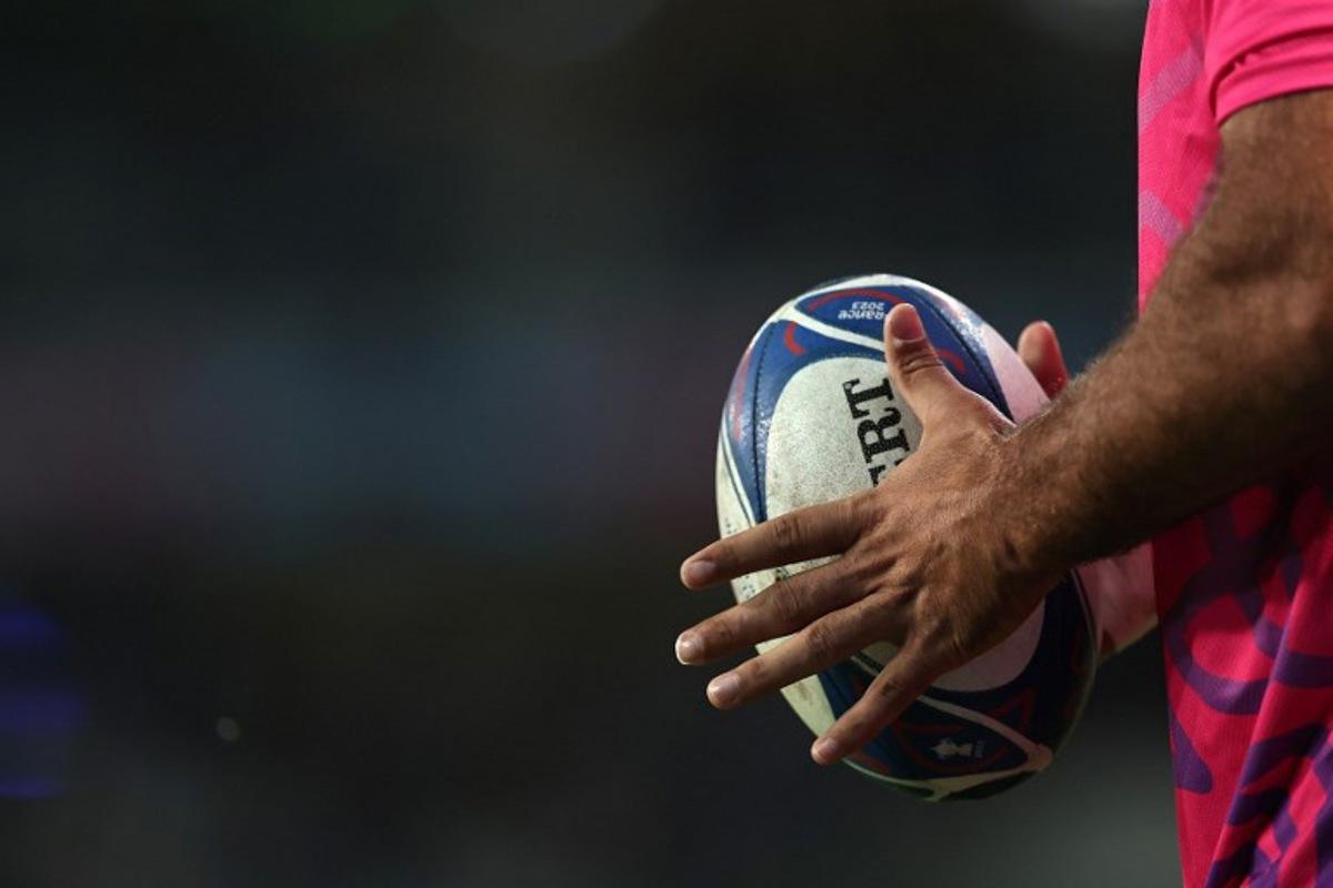 A player holds a rugby ball ahead of the France 2023 Rugby World Cup Pool B match between Scotland and Romania at Pierre-Mauroy stadium in Villeneuve-d'Ascq near Lille, northern France, on September 30, 2023. FRANCK FIFE / AFP