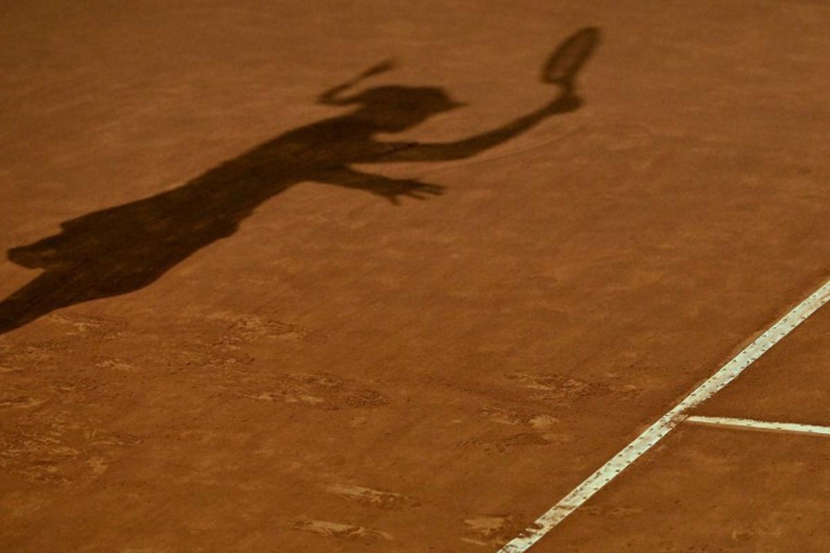 The shadow of Kazakhstan's Elena Rybakina is cast on the clay as she returns to Poland's Iga Swiatek during their quarterfinals match of the Women's WTA Rome Open tennis tournament on May 17, 2023 at Foro Italico in Rome. Tiziana FABI / AFP