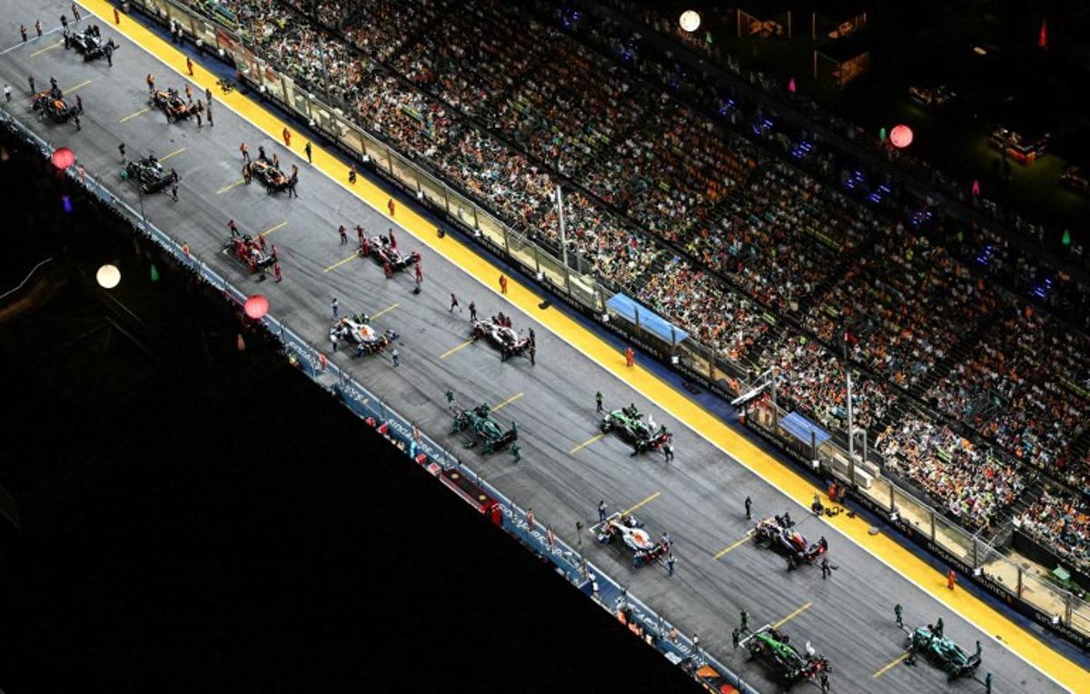 Drivers prepare to take the start of the Formula One Singapore Grand Prix night race at the Marina Bay Street Circuit in Singapore on October 5, 2025. ROSLAN RAHMAN / AFP