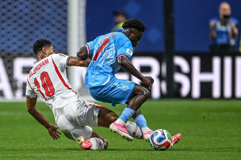 England's midfielder #10 Jude Bellingham and Congo DR's midfielder #07 Nathanael Mbuku fight for the ball during the 2026 World Cup round of 32 match football between England and the Democratic Republic of Congo at the Atlanta Stadium in Atlanta on July 1, 2026. ROBERTO SCHMIDT / AFP