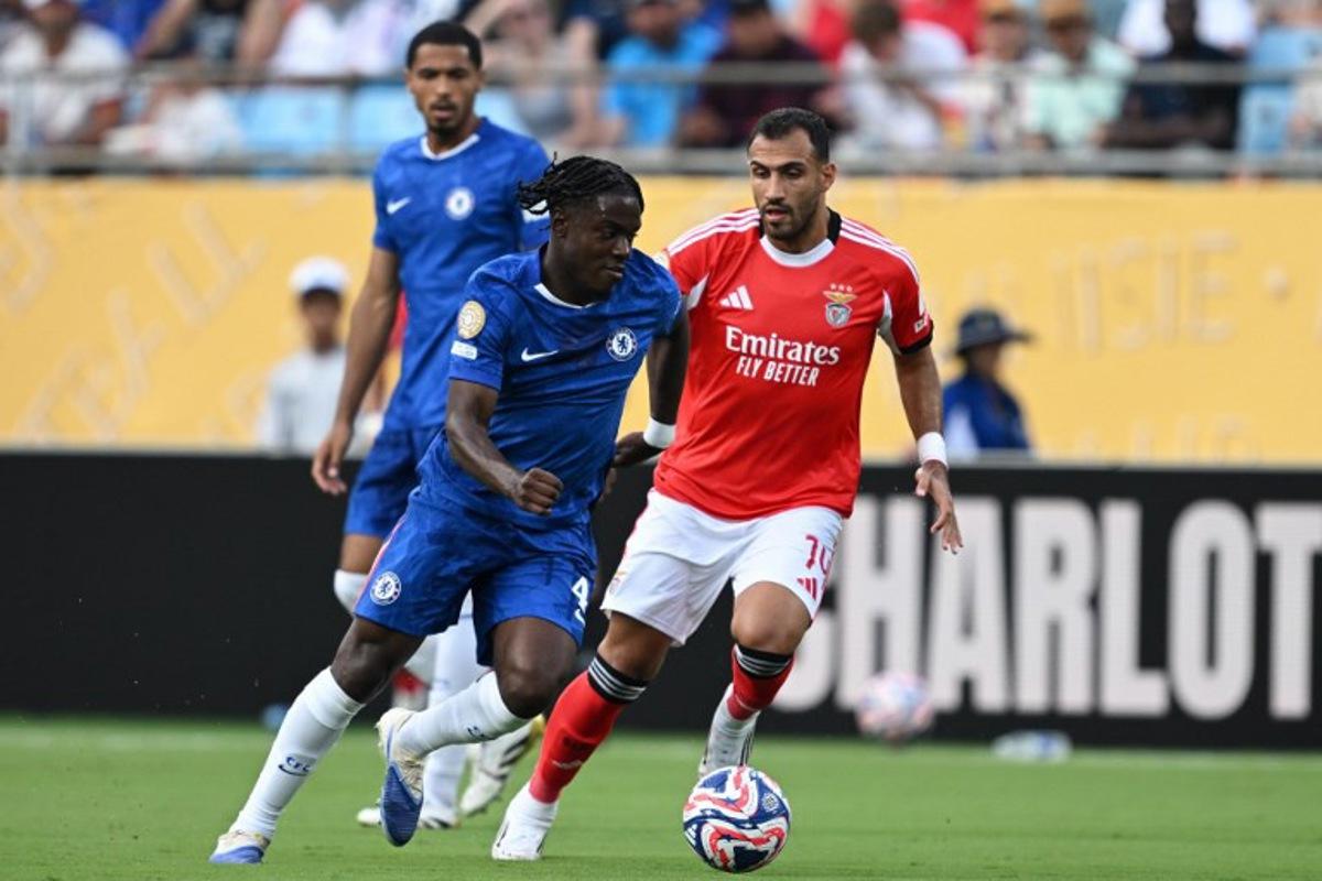 Chelsea's Belgian midfielder #45 Romeo Lavia and Benfica's Greek forward #14 Vangelis Pavlidis fight for the ball during the FIFA Club World Cup 2025 round of 16 football match between Portugal's Benfica and England's Chelsea at the Bank of America Stadium in Charlotte on June 28, 2025. Federico PARRA / AFP