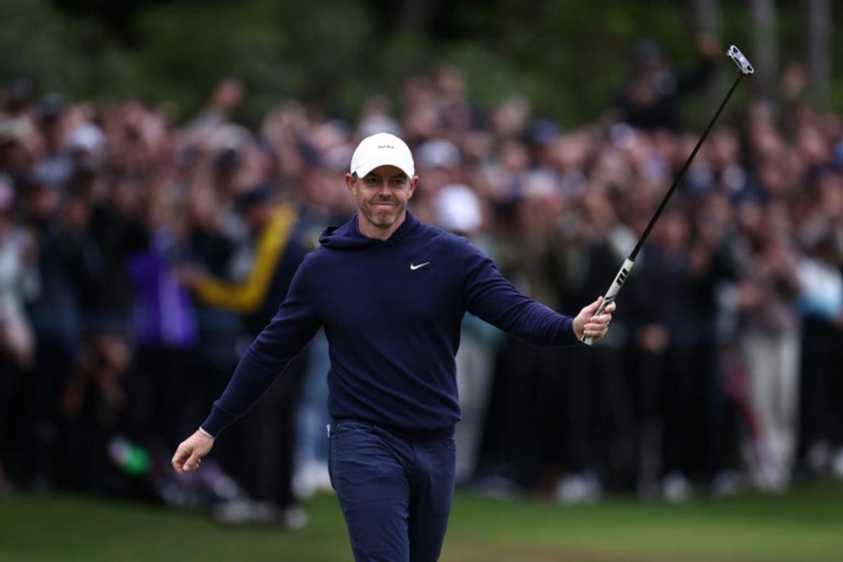 Northern Ireland's Rory McIlroy reacts after sinking his putt on the 18th on the fourth day of the BMW PGA Championship at Wentworth Golf Club, south-west of London, on September 14, 2025. HENRY NICHOLLS / AFP