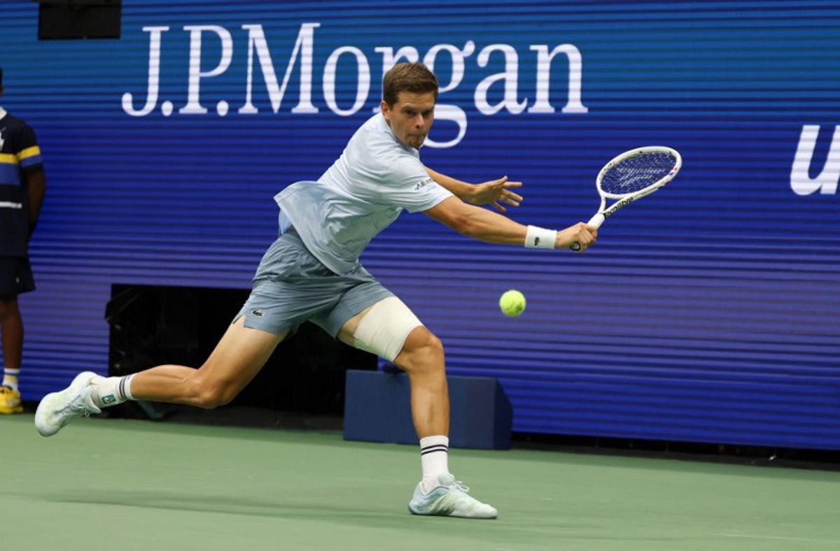 Belgium's Alexander Blockx returns the ball to Russia's Karen Khachanov during the men's singles quarter-final tennis match on day eleven of the US Open tennis tournament at the USTA Billie Jean King National Tennis Center in New York City on September 9, 2026. TIMOTHY A. CLARY / AFP