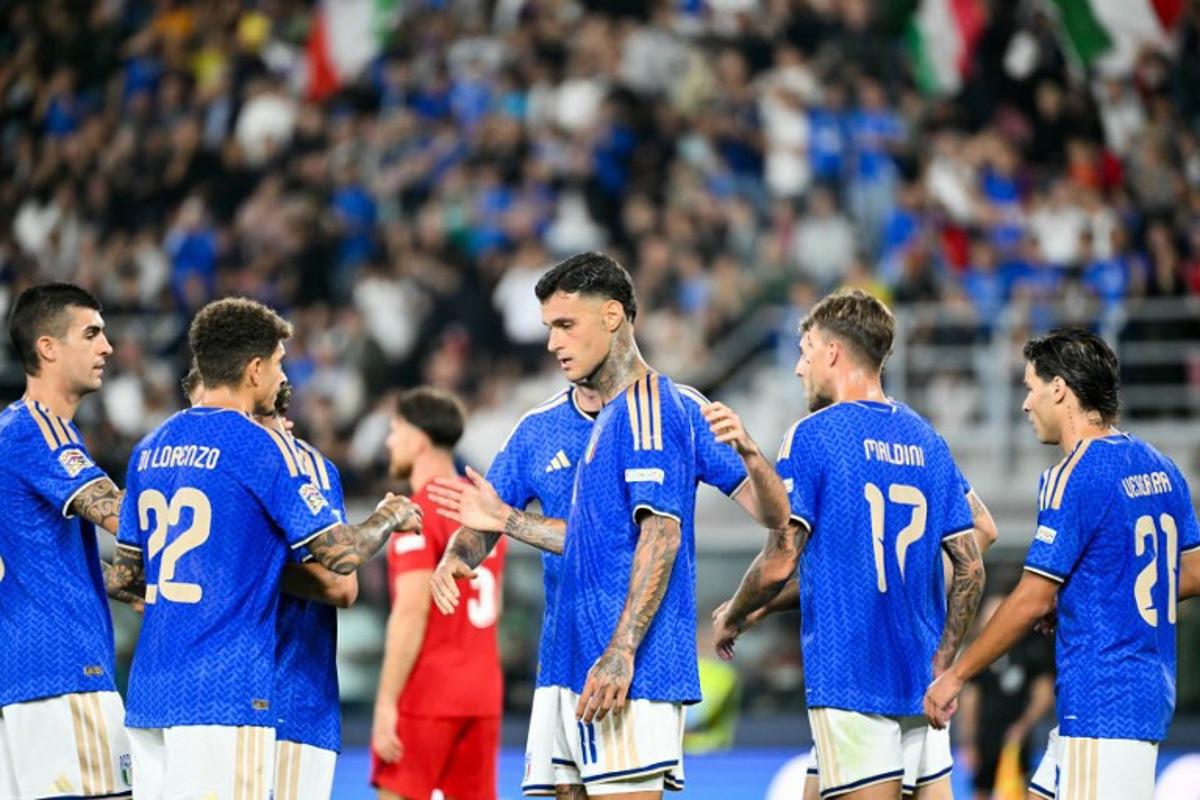 Italy's forward #11 Gianluca Scamacca celebrates after scoring a goal with his teammates during the UEFA Nations League football match (League A day 4, Group A1) between Italy and Turkey at the Renato Dall'Ara Stadium in Bologna on October 5, 2026. Alberto PIZZOLI / AFP