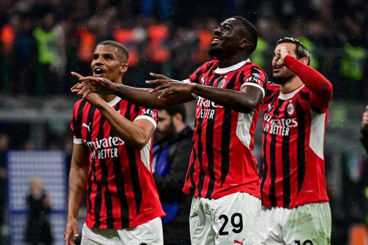 AC Milan's French midfielder #29 Youssouf Fofana celebrates with teammates after their win at the end of the Coppa Italia second leg semi-final football match between Inter Milan and AC Milan at the San Siro stadium in Milan on April 23, 2025. Piero CRUCIATTI / AFP