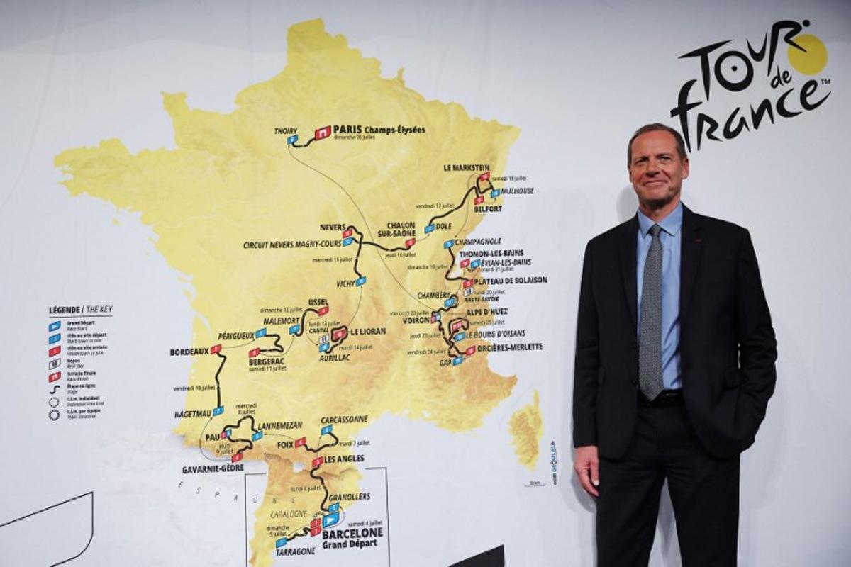 Tour de France General Director Christian Prudhomme poses for a picture in front of the map showing the women's route during the presentation of the official routes of the 2026 edition of the men's and women's Tour de France cycling race in Paris on October 23, 2025. Anne-Christine POUJOULAT / AFP