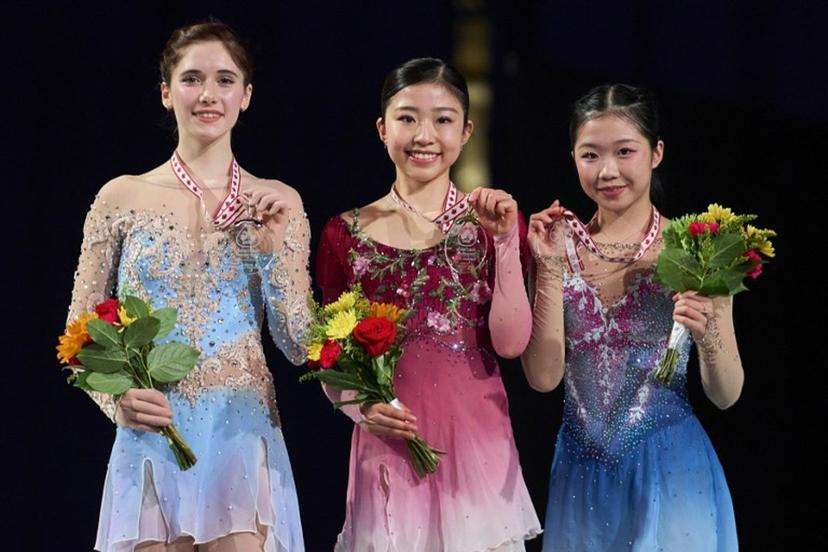 Gold medalist Mone Chiba of Japan (C) poses with silver medalist Isabeau Levito of the United States (L) and Ami Nakai of Japan during the victory ceremony for the women's competition during the ISU Grand Prix of Figure Skating 2025 Skate Canada International at the SaskTel Centre in Saskatoon, Saskatchewan, Canada on November 1, 2025. Geoff Robins / AFP