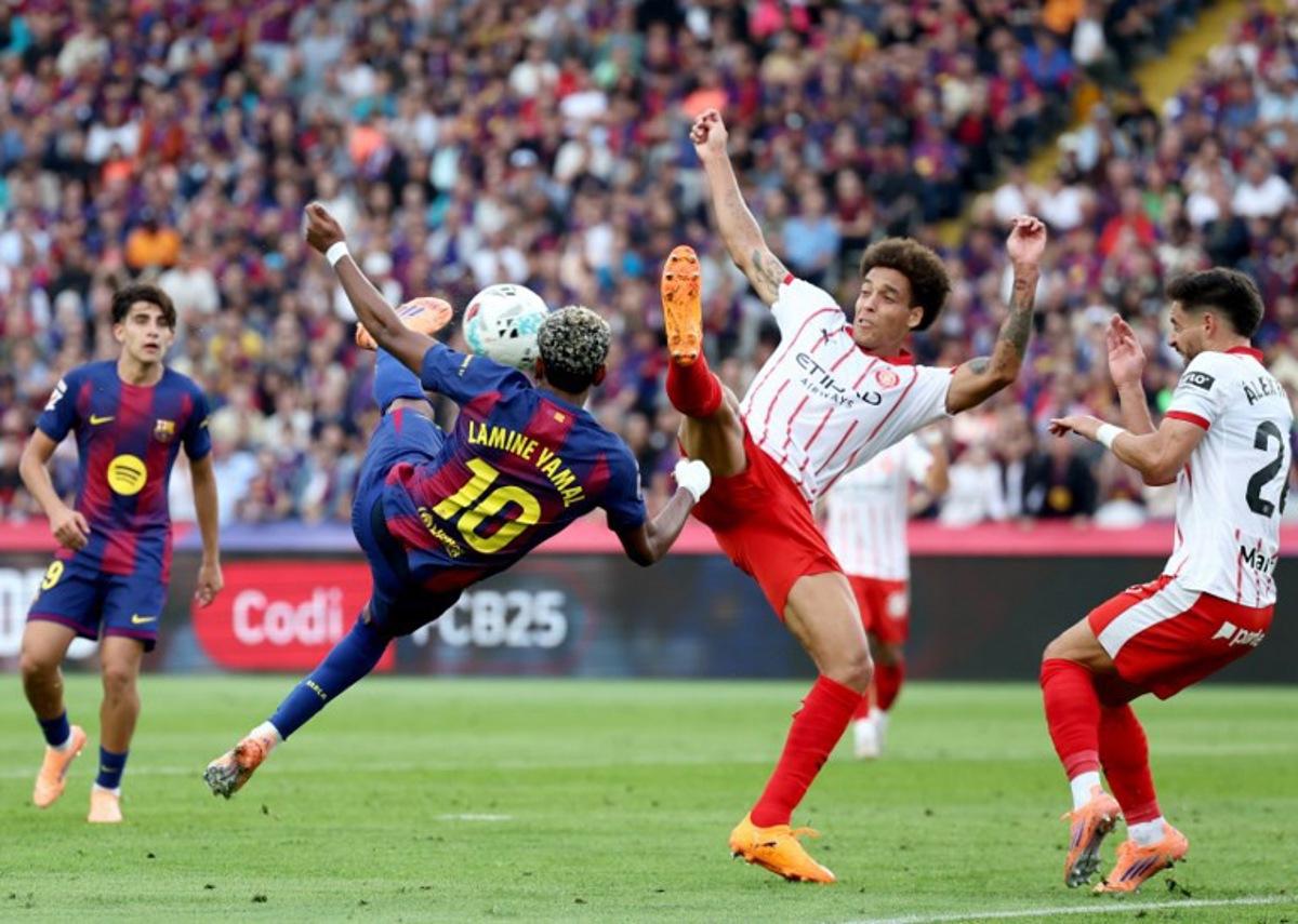 Barcelona's Spanish forward #10 Lamine Yamal fights for the ball with Girona's Belgian defender #20 Axel Witsel during the Spanish league football match between FC Barcelona and Girona FC at Estadi Olimpic Lluis Companys in Barcelona on October 18, 2025. Josep LAGO / AFP