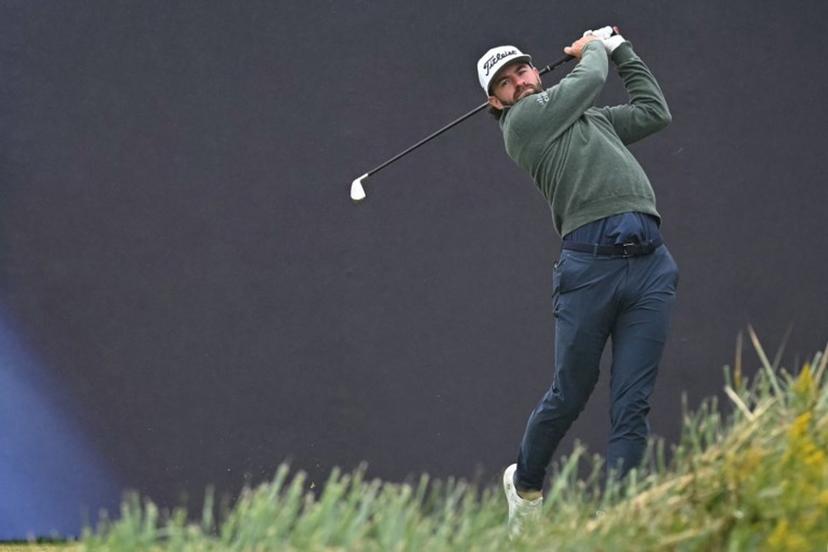 US golfer Cameron Young watches his iron shot from the 1st tee on the opening day of the 152nd British Open Golf Championship at Royal Troon on the south west coast of Scotland on July 18, 2024. Paul ELLIS / AFP