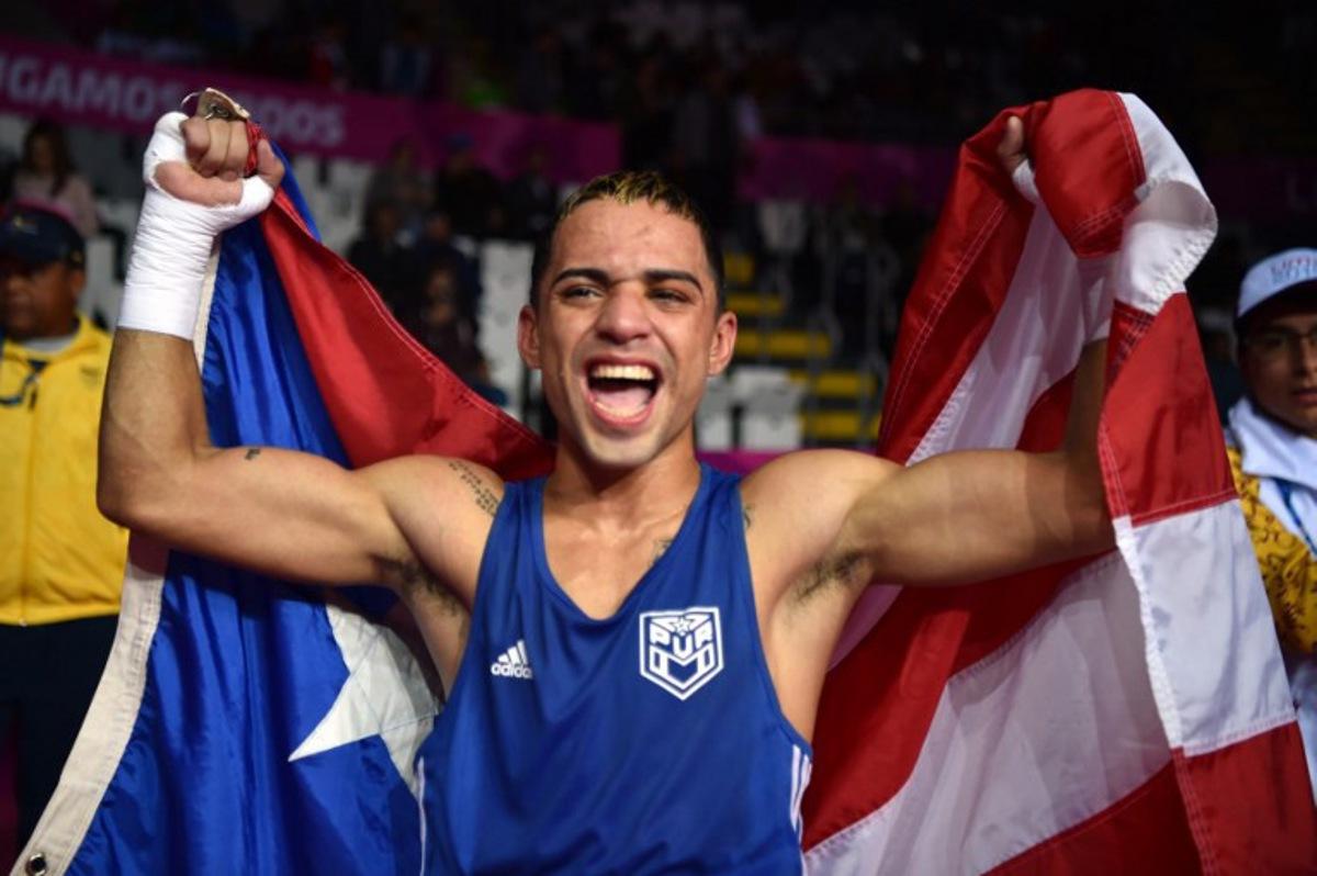 Puerto Rico's Oscar Collazo celebrates after defeating Colombia's Yuberjen Martinez to win the gold medal in the Men's Light Fly (46-49kg) Finals Bout of the Boxing competition Lima 2019 Pan-American Games at the Miguel Grau Coliseum in Callao on August 2, 2019. Cris BOURONCLE / AFP