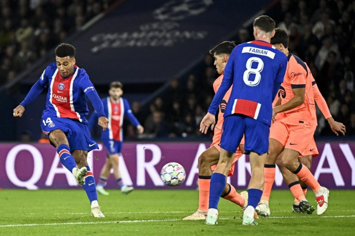 PSG's French forward #14 Desire Doue (L) shoots to score his team's first goal during the UEFA Champions League first round day 3 football match between Paris Saint-Germain (PSG) and FC Barcelona at the Parc de Princes stadium in Paris on October 20, 2026. JULIEN DE ROSA / AFP