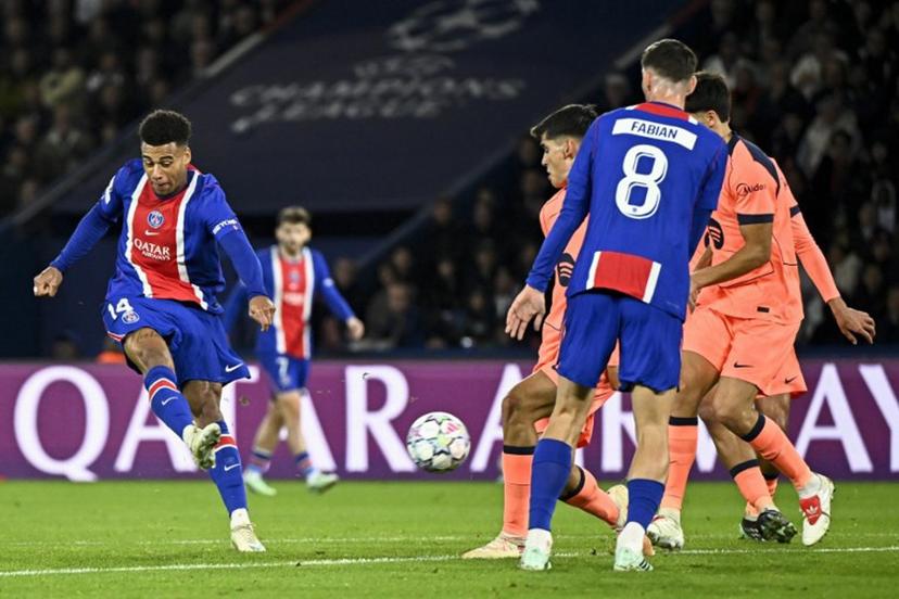 PSG's French forward #14 Desire Doue (L) shoots to score his team's first goal during the UEFA Champions League first round day 3 football match between Paris Saint-Germain (PSG) and FC Barcelona at the Parc de Princes stadium in Paris on October 20, 2026. JULIEN DE ROSA / AFP