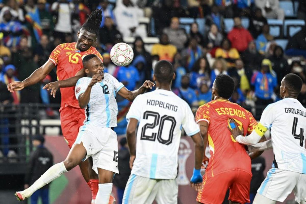 Democratic Republic Of Congo's defender #15 Rocky Bushiri and Botswana's defender #12 Mothusi Johnson vie during the Africa Cup of Nations (CAN) Group D football match between Botswana and Democratic Republic of Congo at El Madina Stadium in Rabat on December 30, 2025. SEBASTIEN BOZON / AFP