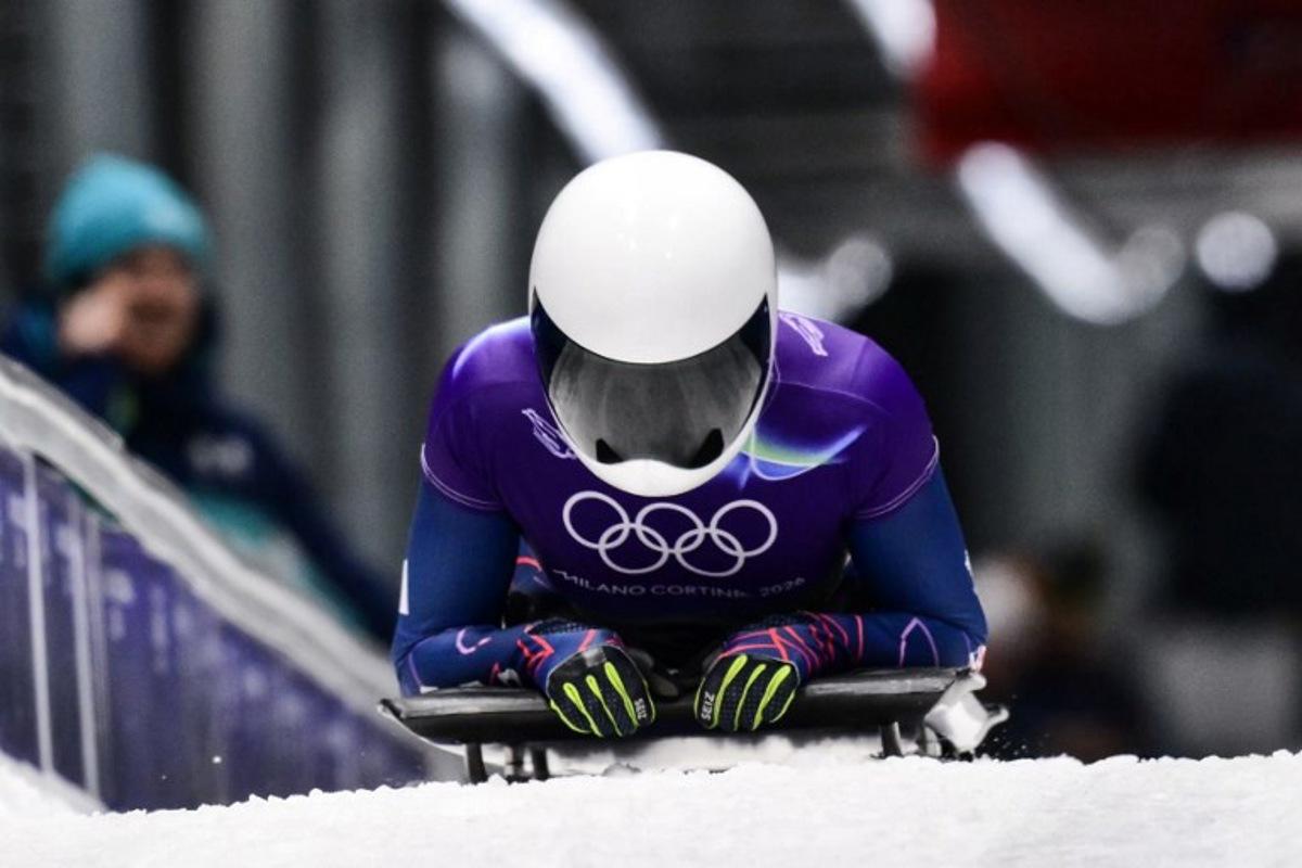 Britain's Tabitha Stoecker arrives to the finish area in the skeleton women's heat 3 at Cortina Sliding Centre during the Milano Cortina 2026 Winter Olympic Games in Cortina d'Ampezzo on February 14, 2026. Stefano RELLANDINI / AFP