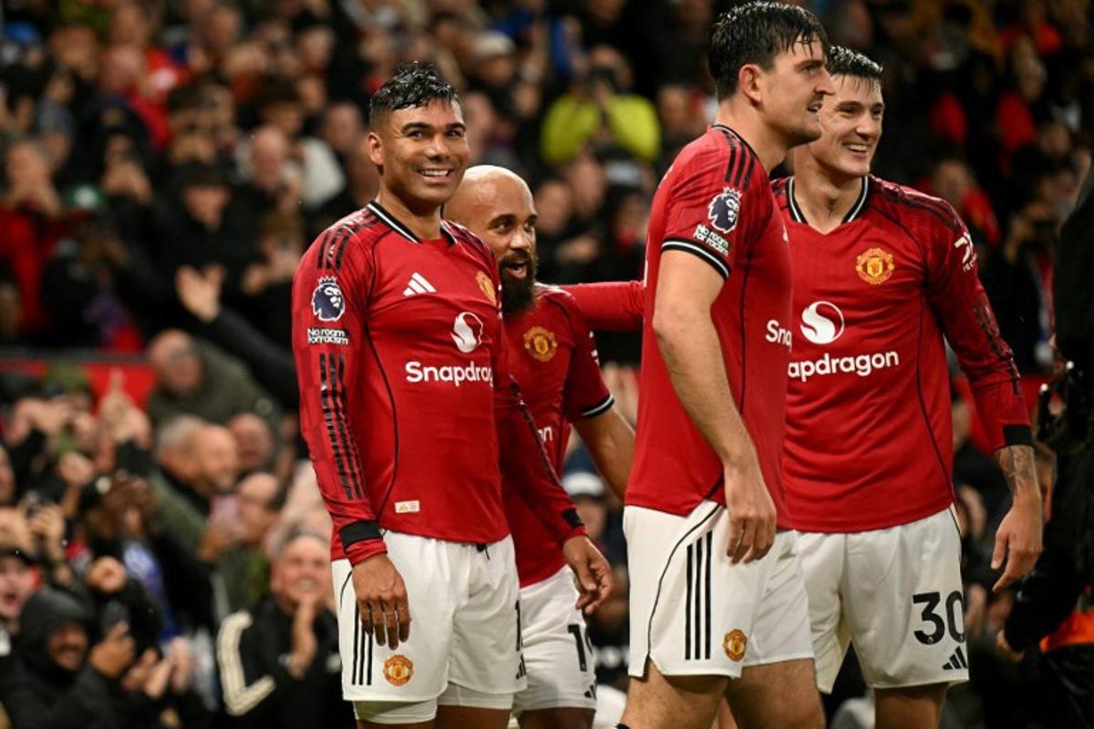 Manchester United's Brazilian midfielder #18 Casemiro (R) celebrates scoring the team's second goal during the English Premier League football match between Manchester United and Chelsea at Old Trafford in Manchester, north west England, on September 20, 2025. Oli SCARFF / AFP