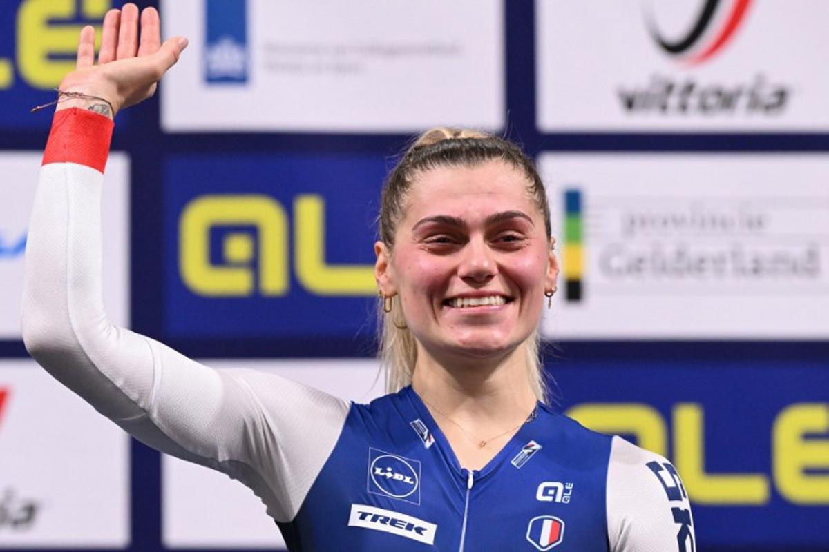 First placed France's Clara Copponi reacts as she celebrates on the podium for the Women's Scratch race during the second day of the UEC European Track Cycling Championships at the Omnisport indoor arena in Apeldoorn, on January 11, 2024. JOHN THYS / AFP