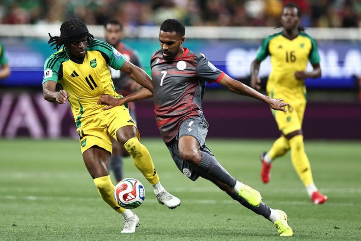 Jamaica's forward #11 Tyreece Campbell and New Caledonia's midfielder #07 Jekob Jeno fight for the ball during the 2026 FIFA World Cup qualifiers semi-final playoff football match between New Caledonia and Jamaica at the Akron Stadium in Zapopan, Mexico on March 26, 2026. Ulises Ruiz / AFP