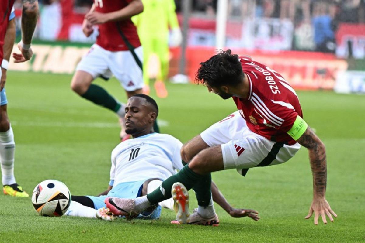 Hungary's midfielder #10 Dominik Szoboszlai (R) and Israel's midfielder #10 Gizacho Gadi Kinda vie for the ball during the International friendly football match between Hungary and Israel in Debrecen, on June 8, 2024. Attila KISBENEDEK / AFP